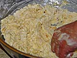 Mixing smoked coconut, rice flour, egg, and sugar