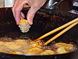 Shrimp toast going into the oil
