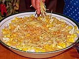Spreading ginger slivers on vermicelli salad