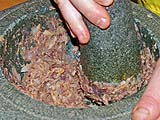 Blending roasted garlic and shallots with roasted shrimp paste