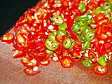 Thinly sliced Thai chillies for the pork