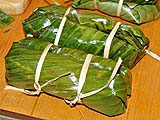 Tightly folded and tied bundles ready to steam