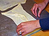 Stretched roti dough formed into a rectangular package