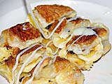 Drizzling sweetened condensed milk on banana roti