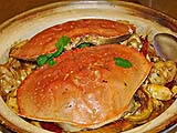 Spicy Hunan crab atop bean threads in a clay pot